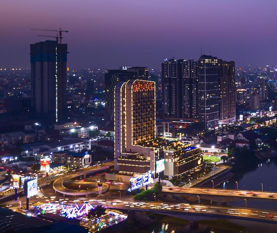 Contemporary exterior and outdoor pool overlooking the river at SUN and MOON Riverside Hotel in Phnom Penh, Cambodia.